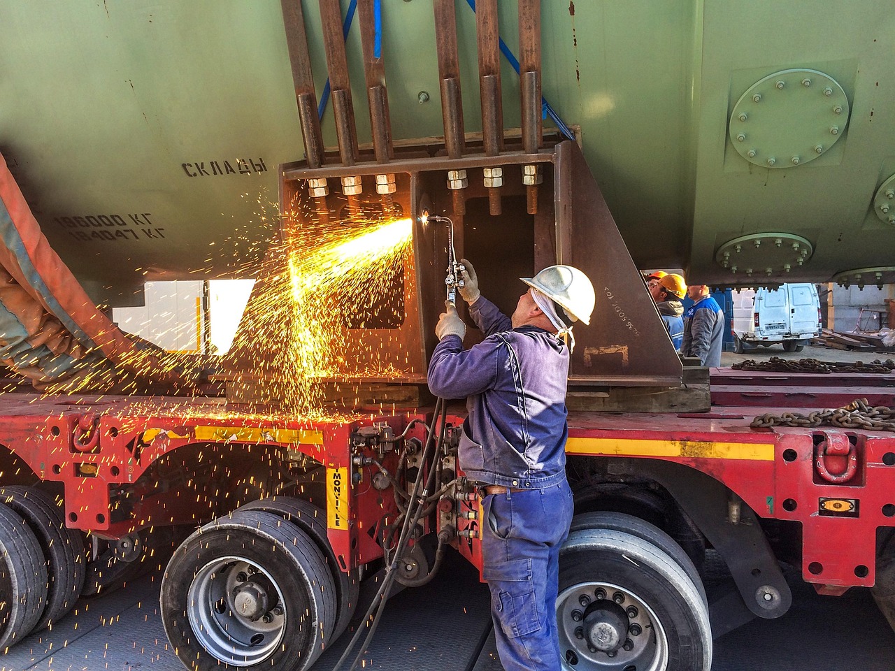 worker, autogen, metal cutting, sparks, melt, construction helmet, wheel, tractor, shipping, cargo, unloading